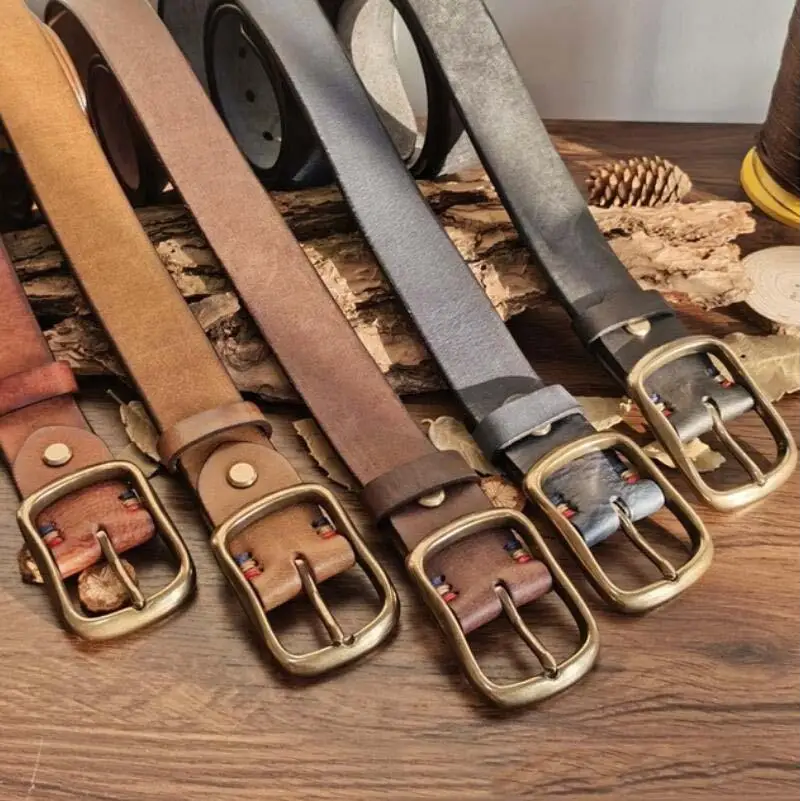 Assorted brown leather belts with brass buckles displayed for the product Assorted Brown Leather Belts with Brass Buckles