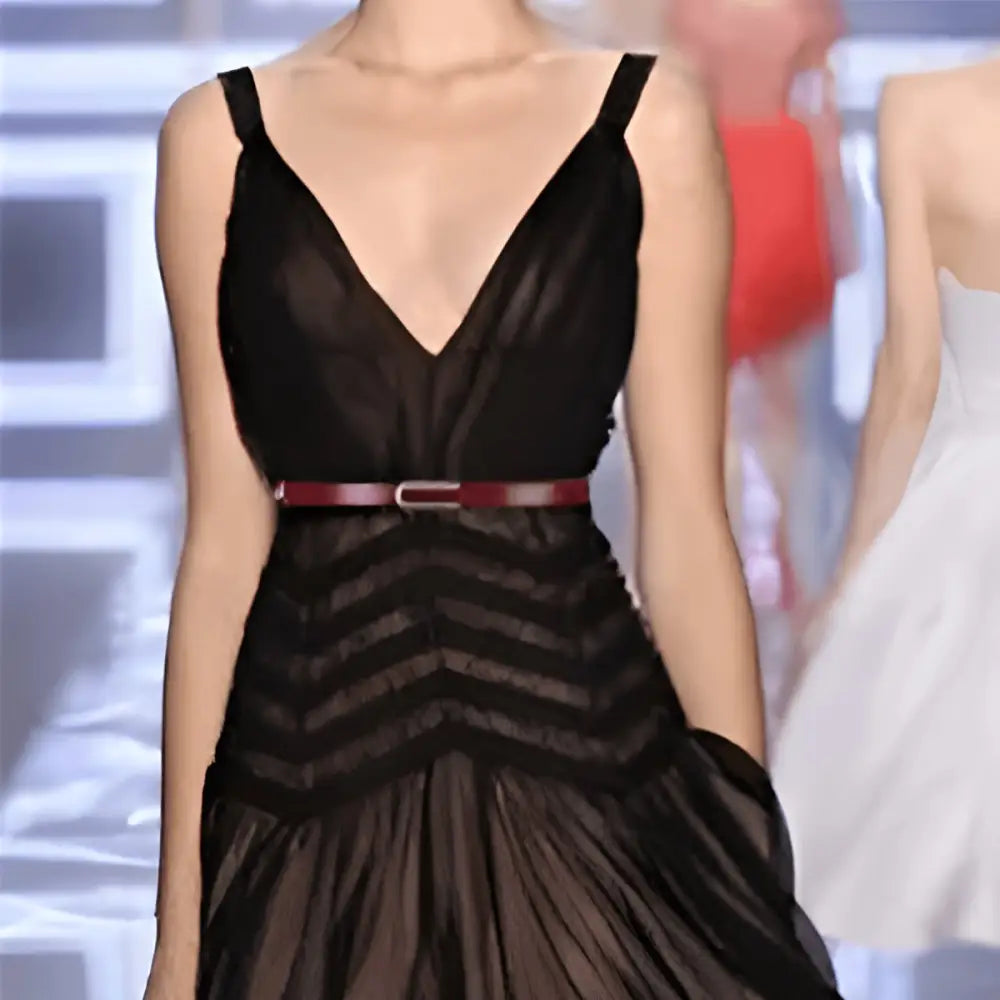 Black V-neck dress paired with a burgundy leather belt featuring a silver buckle