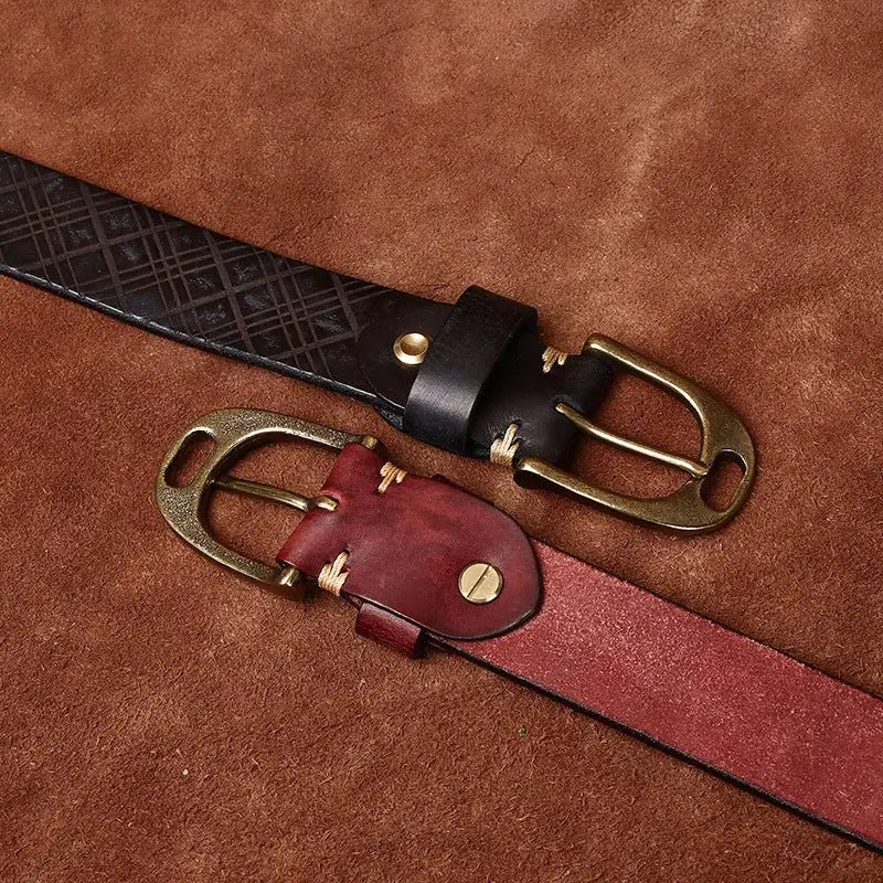 Two embossed leather belts with brass buckles displayed for the Assorted Embossed Leather Belts product
