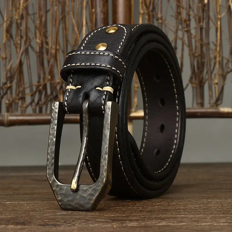 Black leather belt with a hammered metal decorative buckle for stylish accessory