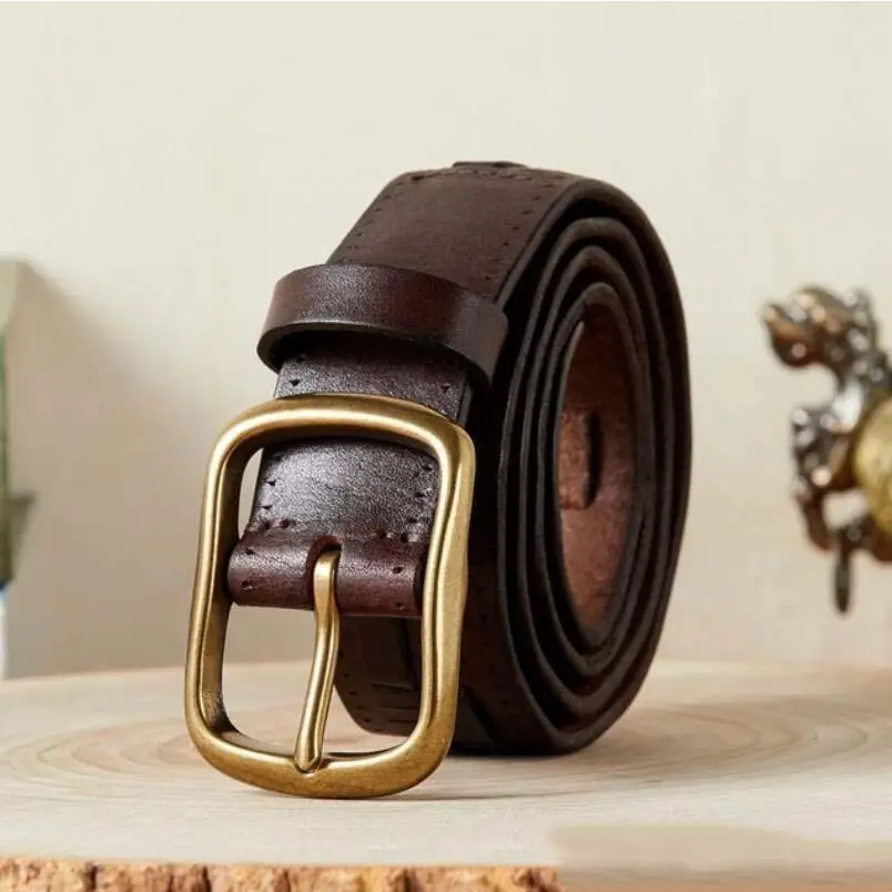 Rolled brown leather belt with brass buckle displayed with Assorted Leather Belts and Two-Tone Denim Jeans