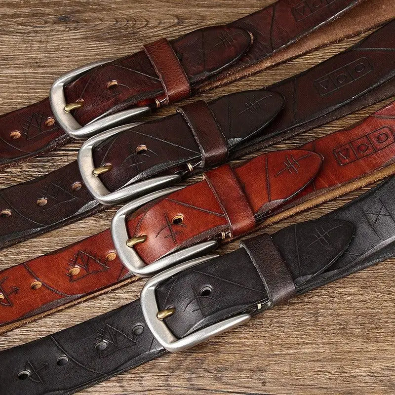 Assorted brown and maroon leather belts with silver metal buckles displayed for sale