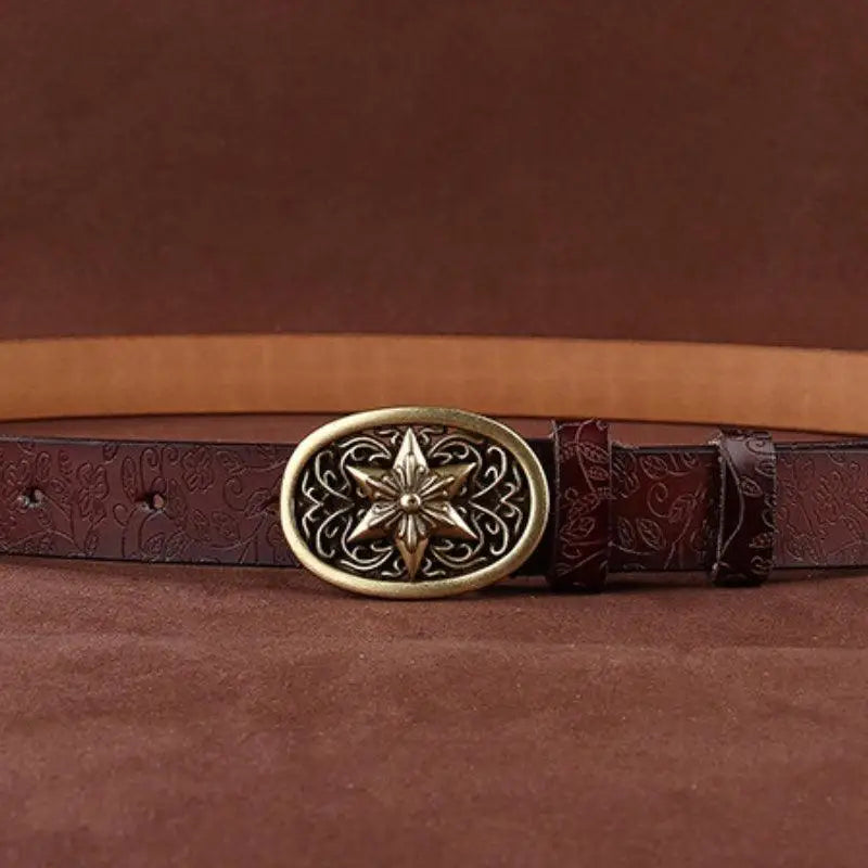 Embossed Sanaa Leather Belt with ornate starburst buckle featuring floral pattern and gold finish