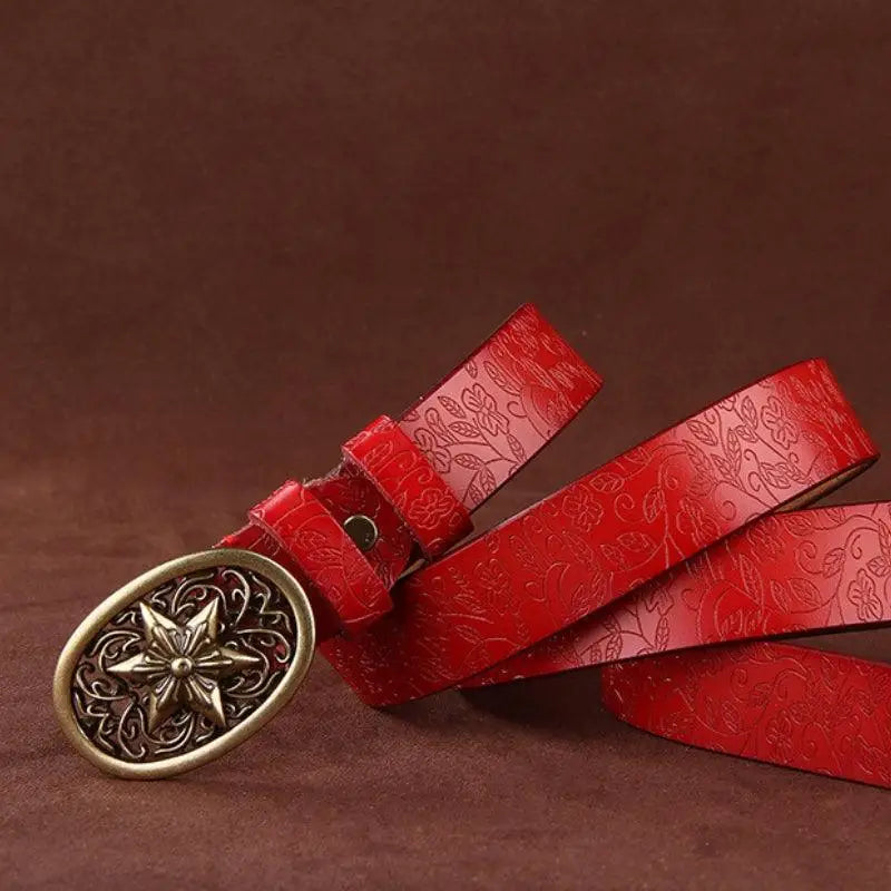 Red leather belt with floral pattern and ornate gold star buckle from Sanaa Leather Belt collection