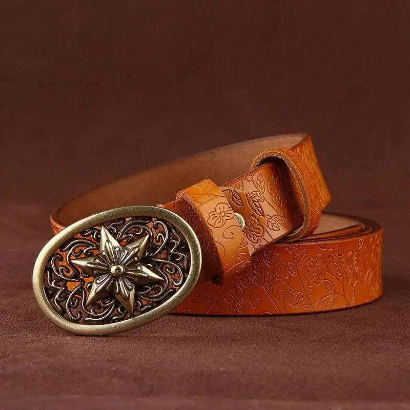 Embossed brown Sanaa Leather Belt with ornate gold star buckle and floral pattern