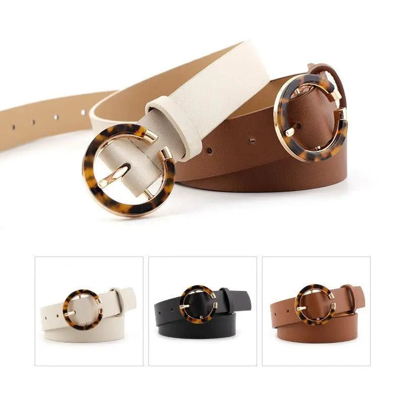 Set of three stylish faux leather and leather belts with circular buckles for fashion