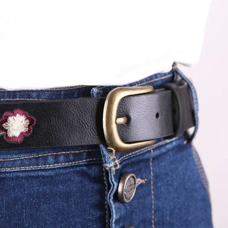 Embroidered black leather belt with brass buckle featuring faux leather for women