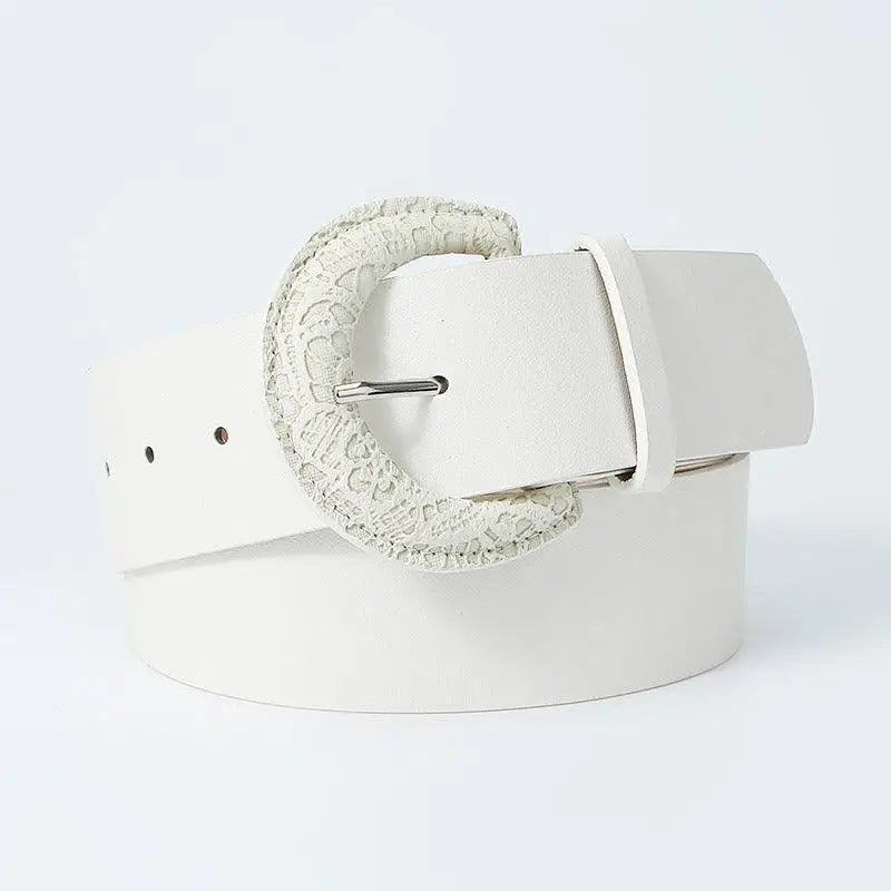 White faux leather belt featuring a decorative textured buckle for stylish accessories