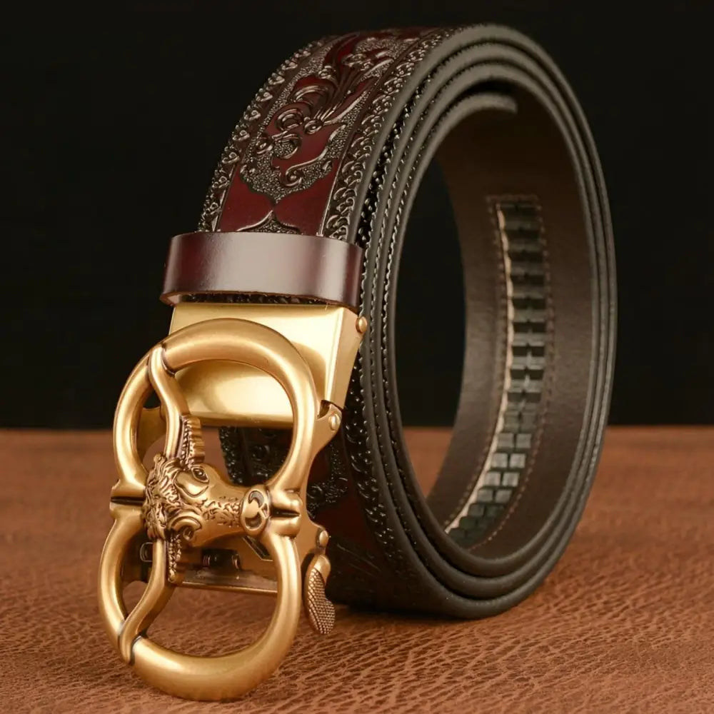 Embossed leather belt with ornate gold buckle showcasing esprit animal motif and bull head design