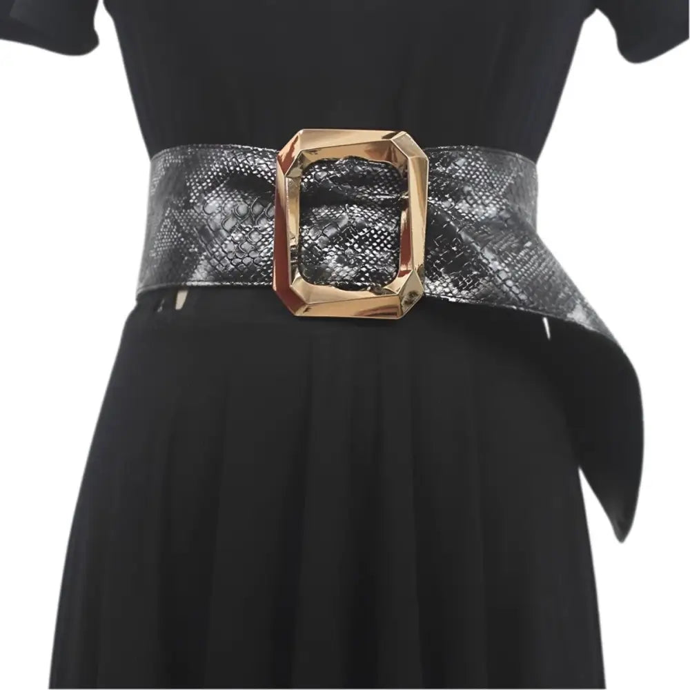 Leopard print belt with gold buckle worn with black dress for stylish fashion statement