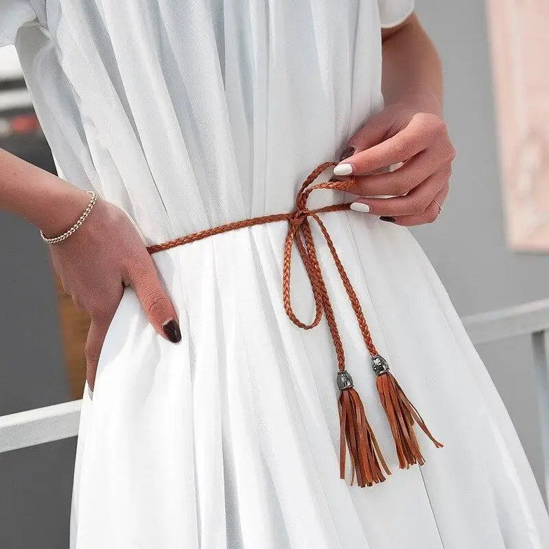 White dress with braided brown Tumunia Model Tie Belt featuring tassel detailing