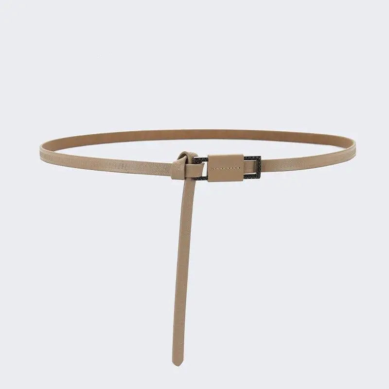 Beige leather belt with dark buckle from Assorted Leather Belts with Decorative Buckles