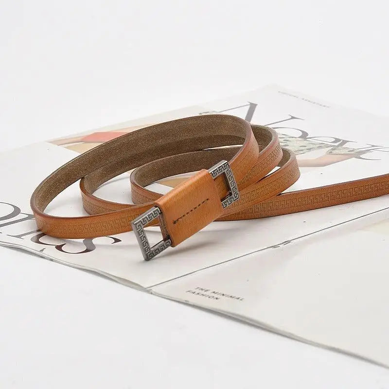 Tan leather belt with a patterned decorative buckle featured in Assorted Leather Belts collection