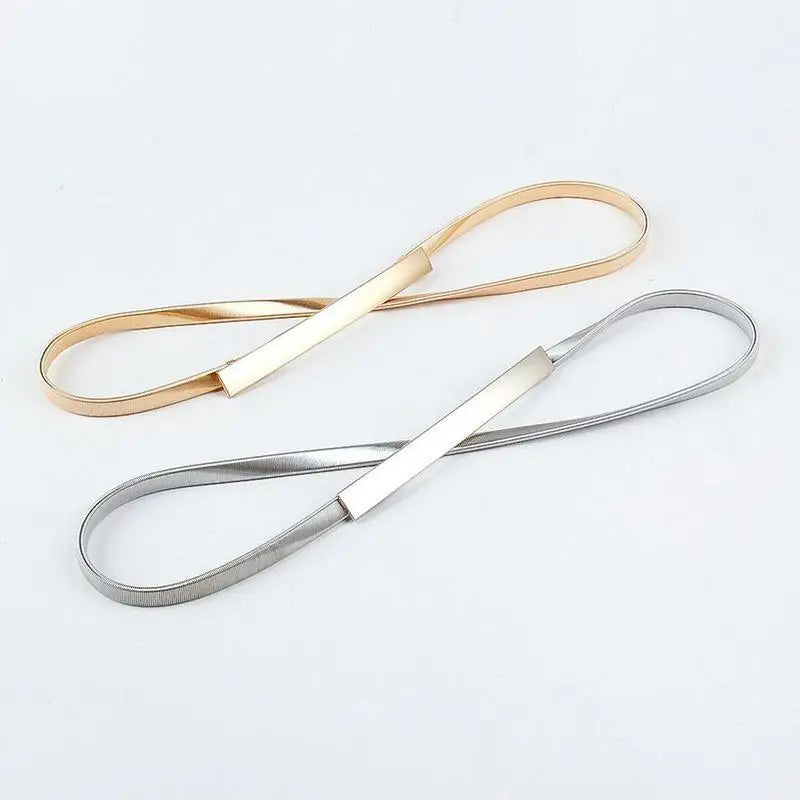 Gold and silver metal belts on Dhoxia Slim Belt with gold-toned buckle for elegant fit