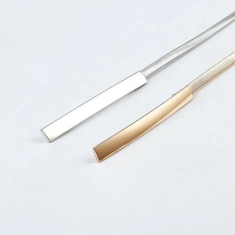 Silver and gold metal belts from Dhoxia Slim Belt with elegant gold-tone buckle