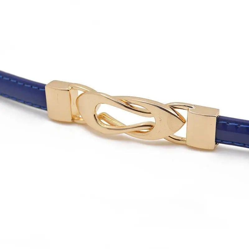 Blue patent leather belt with a gold knot buckle for stylish accessorizing