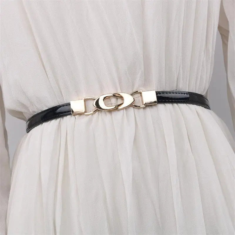 Black patent leather belt with a gold decorative buckle for stylish accessories