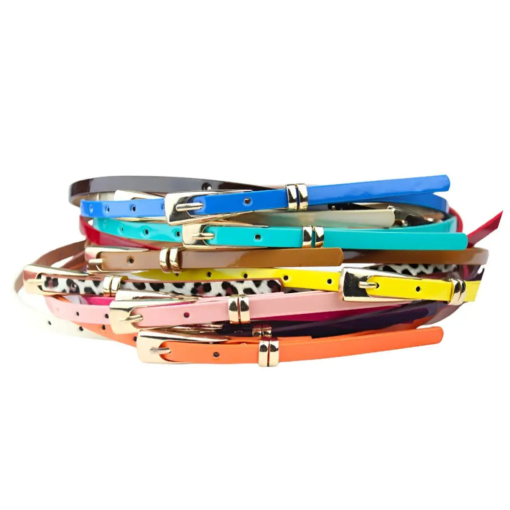 Pile of colorful skinny belts including a stylish Phoenix belt accessory