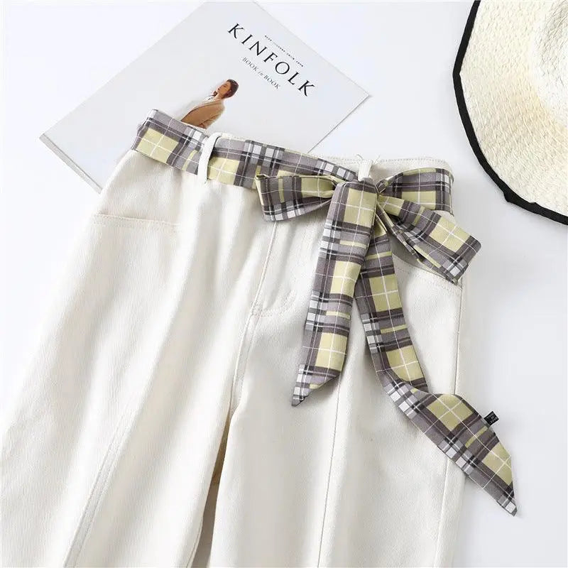 White shorts with plaid scarf belt and tie details for a stylish look