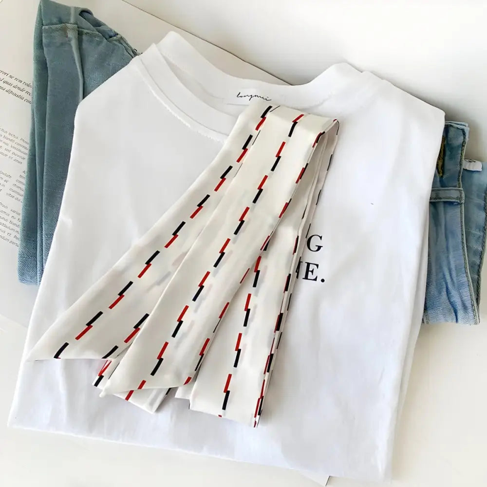 Casual clothing arrangement with Lento Scarf Belt featuring red and black dashes for denim shorts