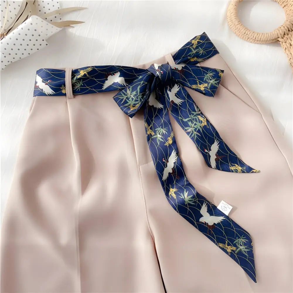 Beige shorts with stork pattern and navy silk scarf belt in Blue Crane Set