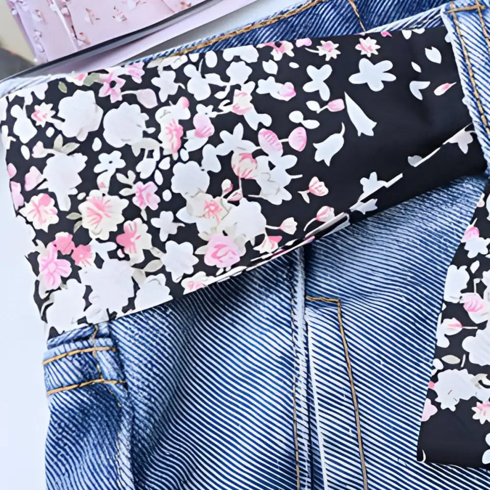 Blue jeans featuring a floral scarf belt and matching floral print scarf for stylish wear