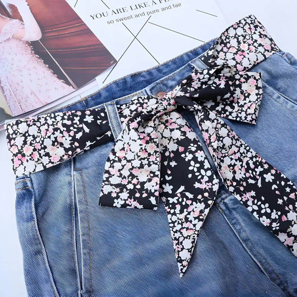 Blue jeans with stylish floral scarf belt and matching floral print scarf for a chic look