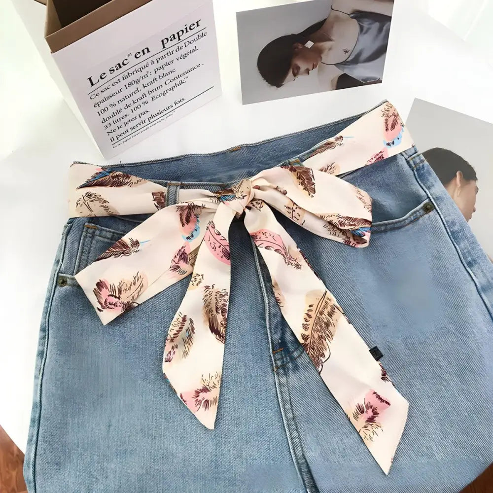 Denim skirt with feather-patterned scarf belt for stylish outfits and accessories