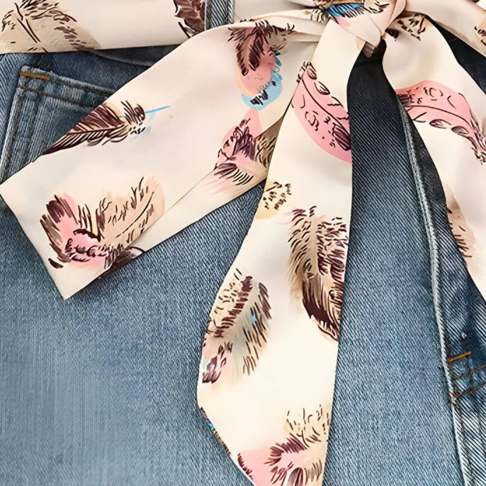 Feather pattern scarf belt tied on denim for stylish outfits and denim skirts