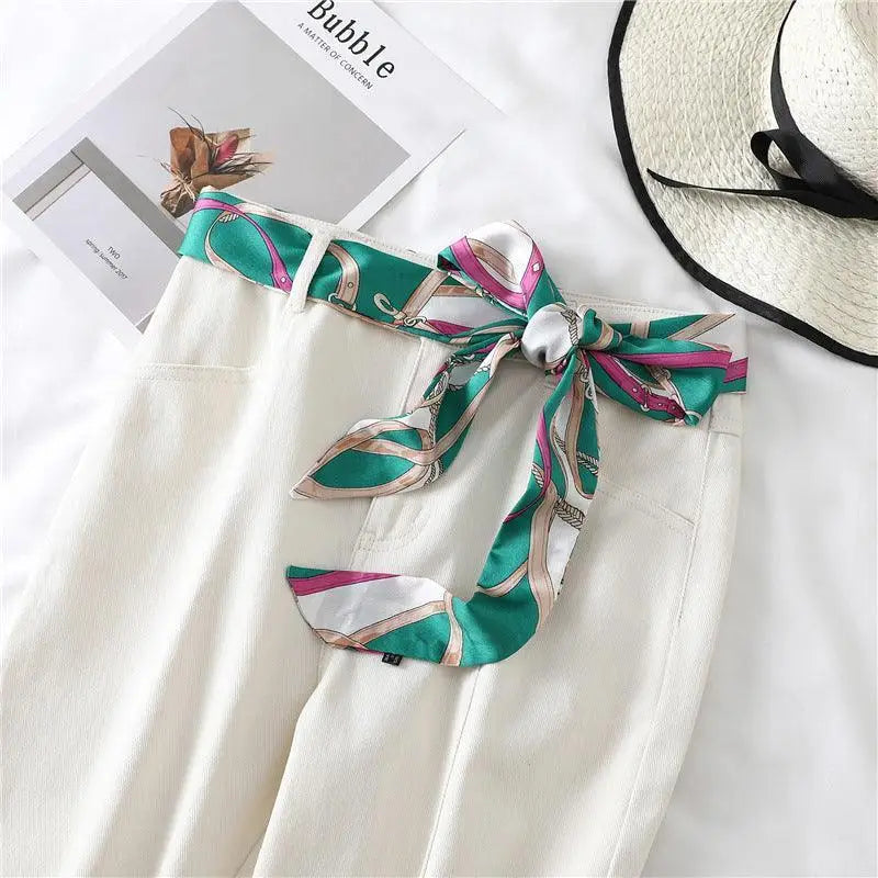 White pants with Betina scarf belt in patterned and solid styles showcasing a stylish scarf belt
