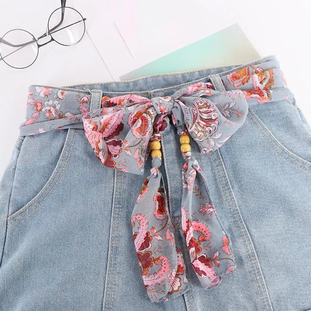 Denim skirt with floral scarf belt featuring Hokoupadia Model Scarf Belt accessory