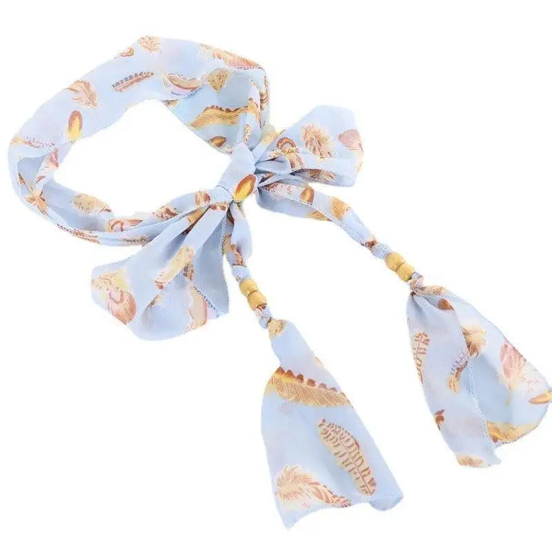 Light blue patterned scarf belt with beaded ties from Hokoupadia Model Scarf Belt collection