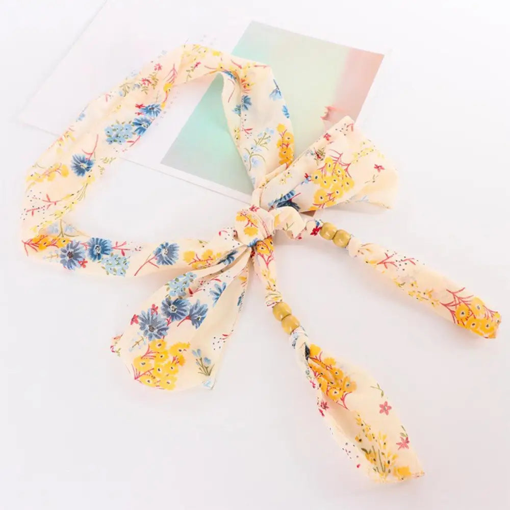 Floral print hair tie with wooden beads paired with Hokoupadia model scarf belt