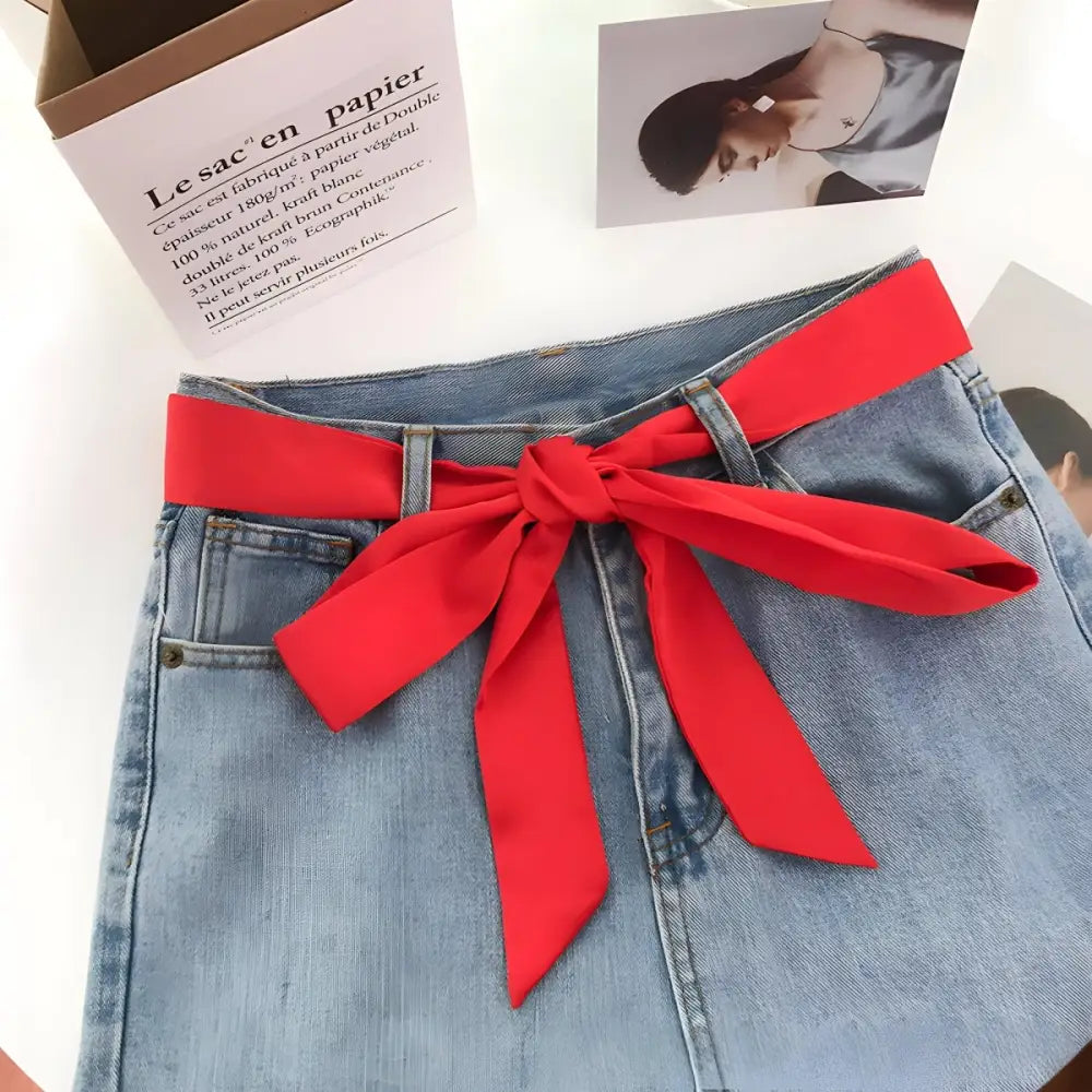 Blue denim shorts with red scarf belt for casual style and versatile fashion image