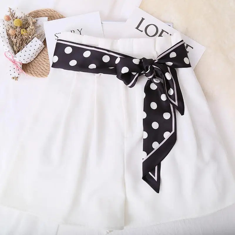 White shorts with a stylish polka-dotted silk scarf-belt for elegant summer wear