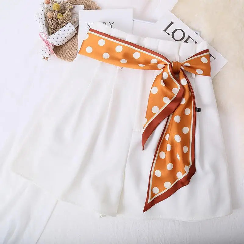 White shorts with stylish polka-dotted silk scarf-belt for a chic summer look
