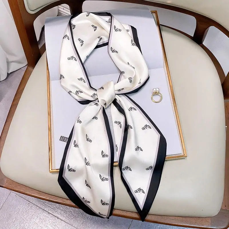 Elegant white silk scarf belt with black trim and bee pattern for a stylish look