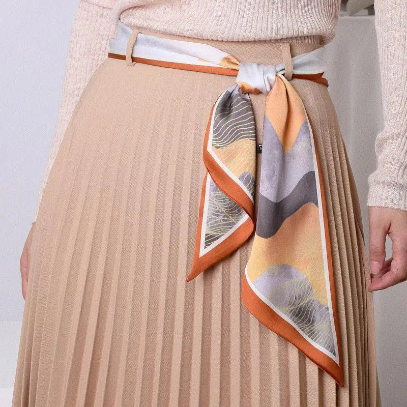 Pleated skirt with patterned silk scarf belt for elegant style and sophisticated look