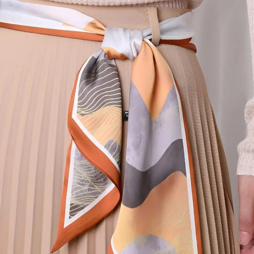 Elegant pleated skirt with patterned silk scarf belt for a sophisticated style