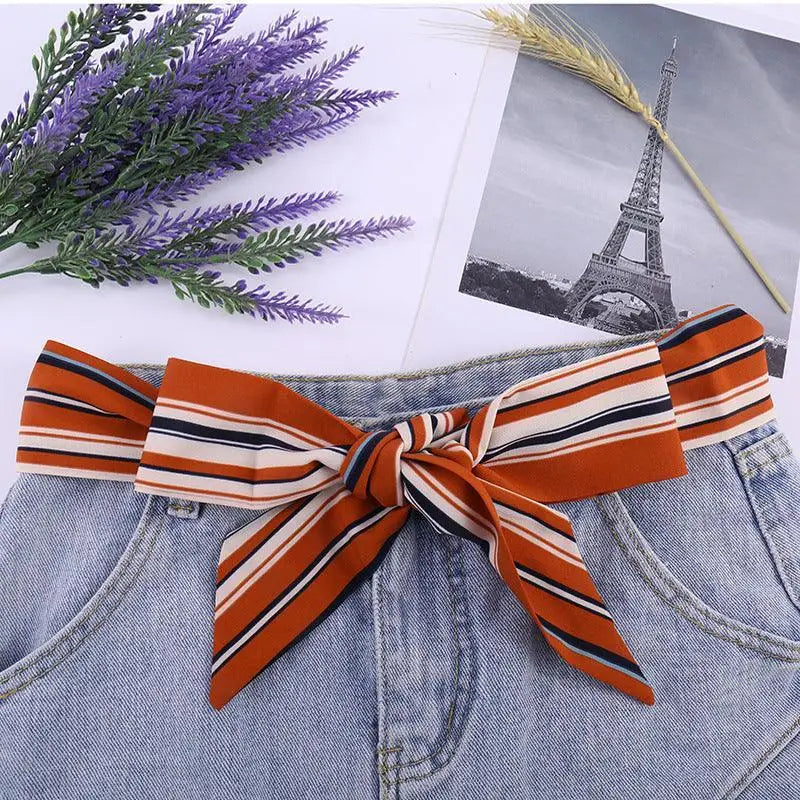 Silk scarf belt with striped bow detail styled with denim shorts for a chic look