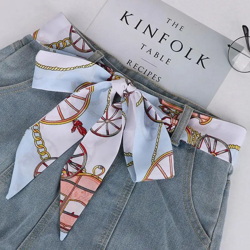 Denim skirt with elegant silk scarf-belt and patterned denim shorts detail