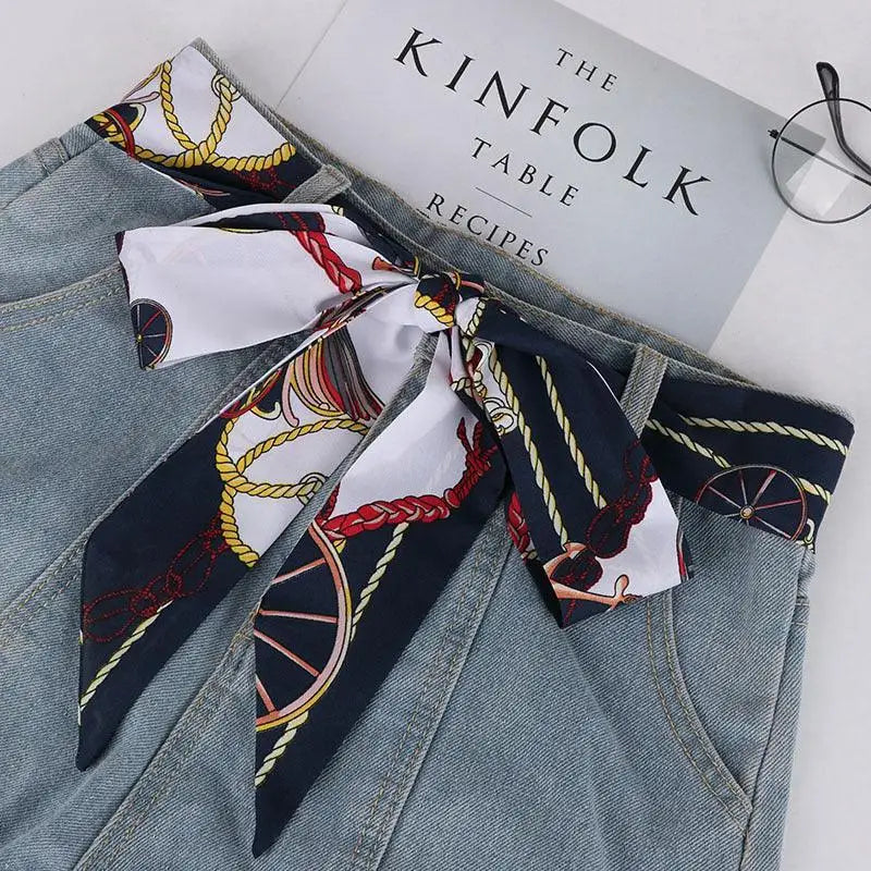 Denim skirt with elegant silk scarf-belt showcasing nautical style for a chic look