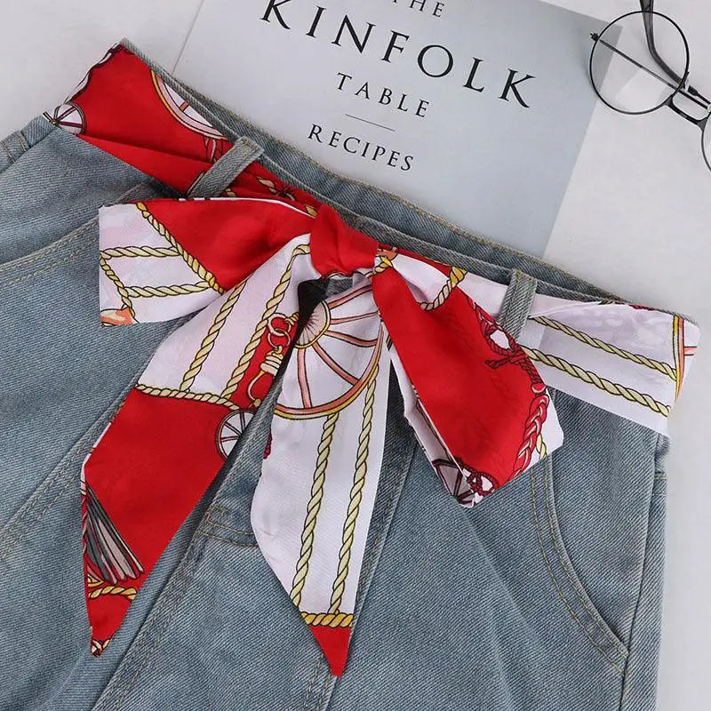 Elegant denim skirt with red and white patterned silk scarf-belt for a stylish look