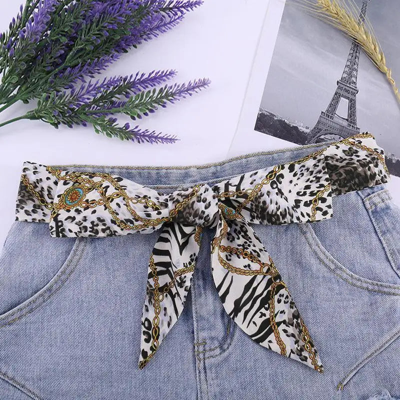 Animal print silk scarf belt from Sanne Silk complements denim shorts stylishly