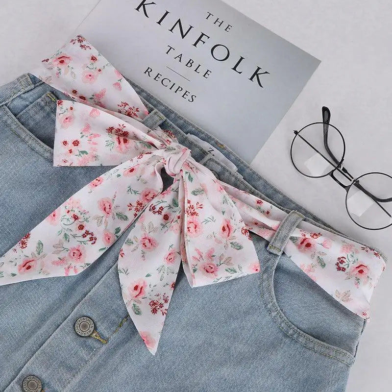 Denim skirt with floral sash featuring Yrsa silk scarf-belt for a feminine look