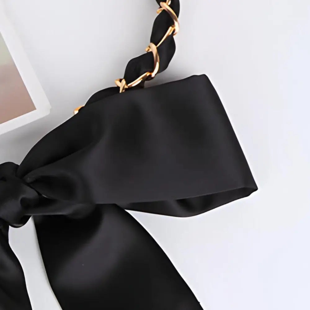 Black satin bow headband with gold chain paired with Oriana silk scarf for elegant style