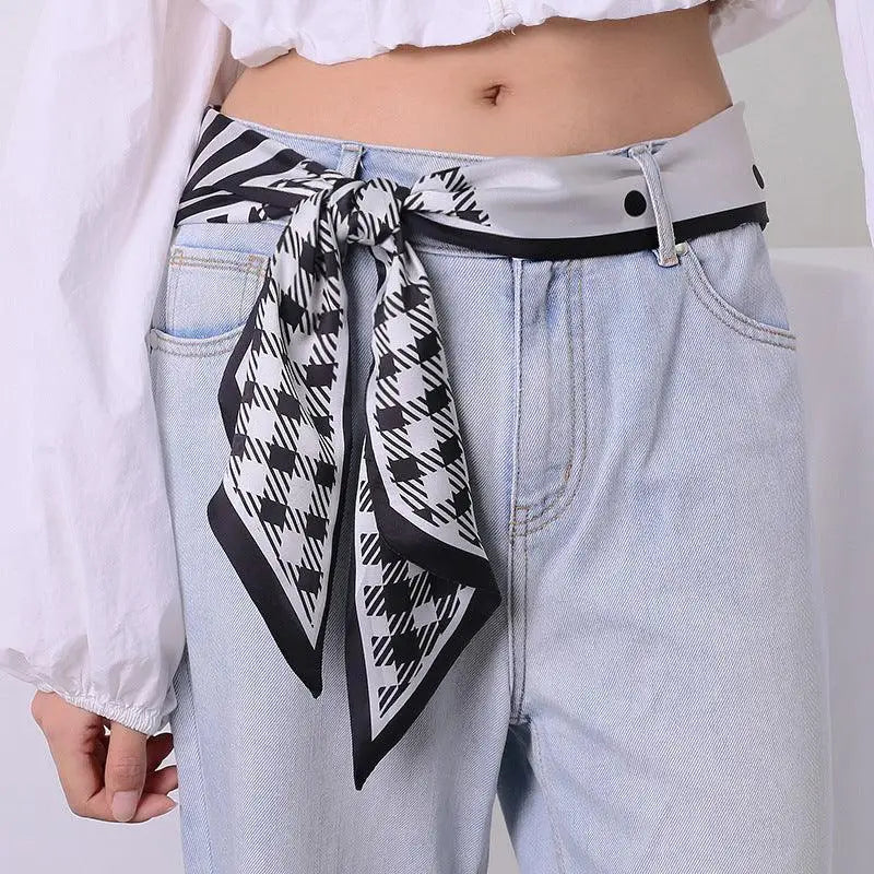 Light-wash jeans with styled Rinia scarf belt for a fashionable look
