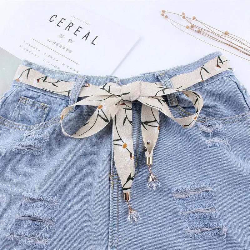 Ripped denim shorts with floral scarf belt for casual style and trendy look