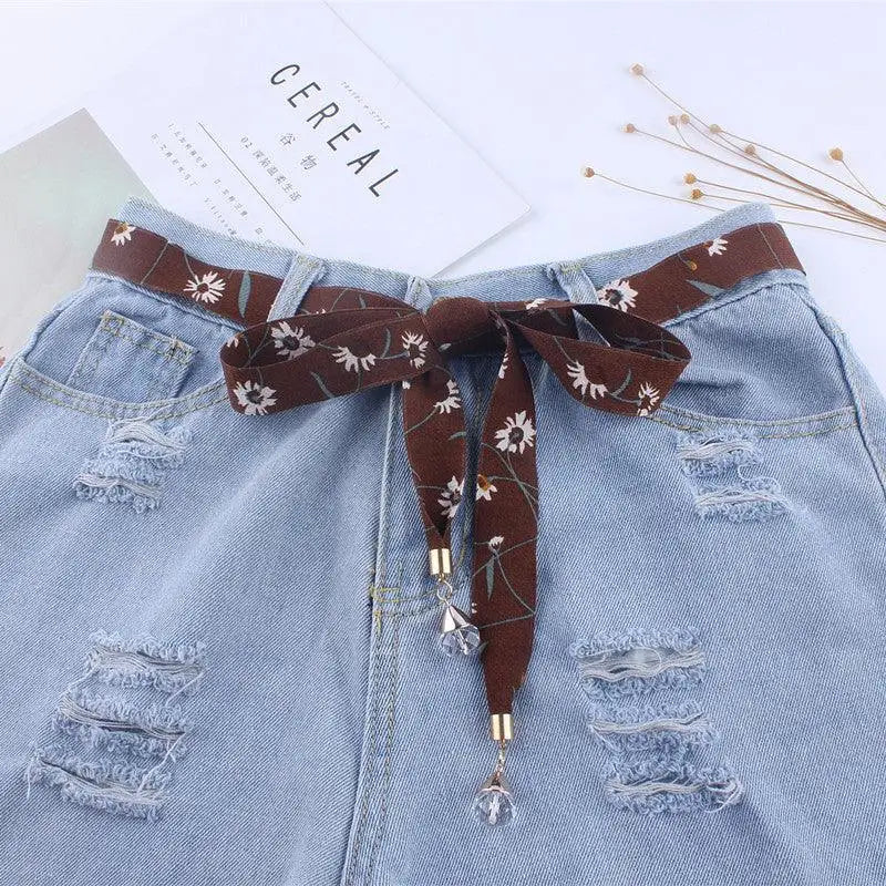 Ripped denim shorts with floral scarf belt for casual style perfect for summer wear
