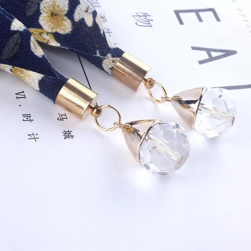 Floral scarf with crystal pendants used as a stylish scarf belt for casual attire
